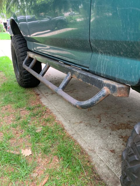 1996 Ford Bronco - This vehicle features side steps and off-road tires, suggesting it's equipped for tougher terrain.