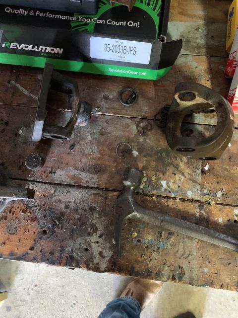 1996 Ford Bronco - Workbench with disassembled vehicle parts, tools, and a box from Revolution Gear.