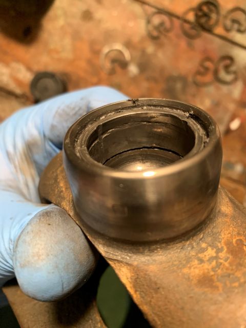 1996 Ford Bronco - Close-up of a worn metal bearing component, suggesting mechanical work.