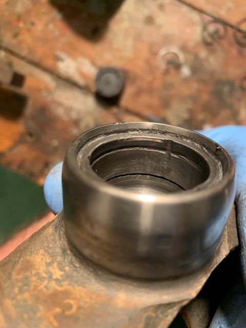 1996 Ford Bronco - Close-up view of a damaged bearing race, showing signs of wear and scoring.