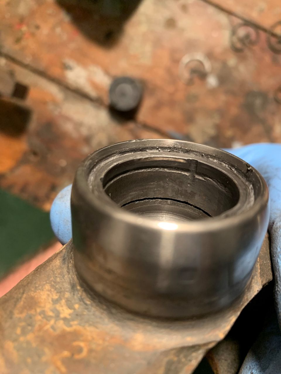 Worn bearing race with visible scoring and damage