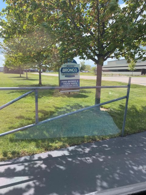 1996 Ford Bronco - A sign indicates a distribution center for Ford Bronco and truck parts.