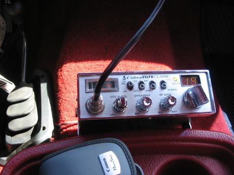 1989 Ford Bronco - close up of the CB in it's upright position on the front of the console/cup holder box.