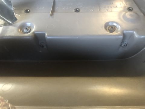 1995 Ford Bronco - Interior plastic trim panel showing screw mounts and molded-in text.