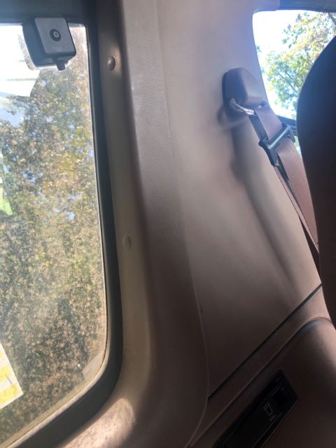 1995 Ford Bronco - Interior view of a vehicle's pillar and seatbelt, with a watermark indicating the source.
