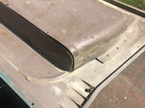 1995 Ford Bronco - Close-up of a car's interior trim piece, showing signs of age and dust accumulation.