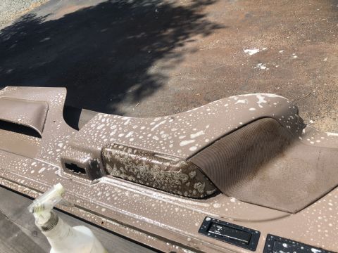 1995 Ford Bronco - Interior panel being cleaned with soap and water, showing the cleaning process.