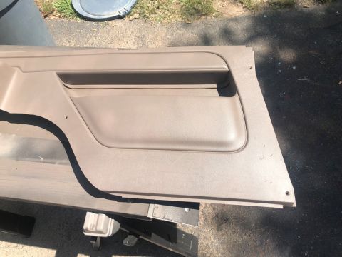 1995 Ford Bronco - Car door panel removed for interior work, showing the armrest and storage pocket.