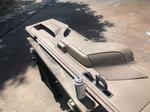 1995 Ford Bronco - A car door panel is shown with a spray can, suggesting an interior redo project.