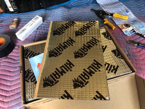 1995 Ford Bronco - Sound deadening material is laid out with tools, suggesting an interior modification project.