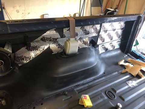 1995 Ford Bronco - Sound dampening material is applied to the interior rear panel of a vehicle.