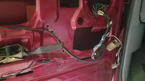1994 Ford Bronco - Exposed wiring and door latch mechanism visible inside a car door panel.
