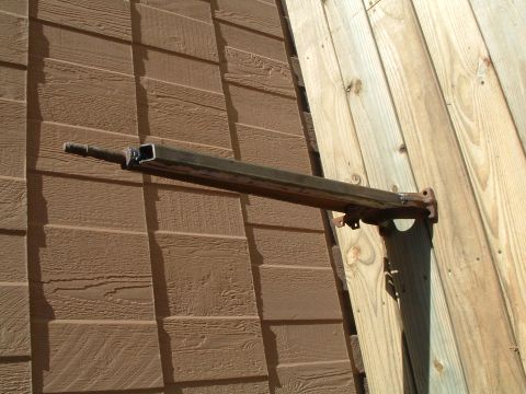 1979 Ford Bronco - A metal bracket is mounted on a wall and a wooden post.