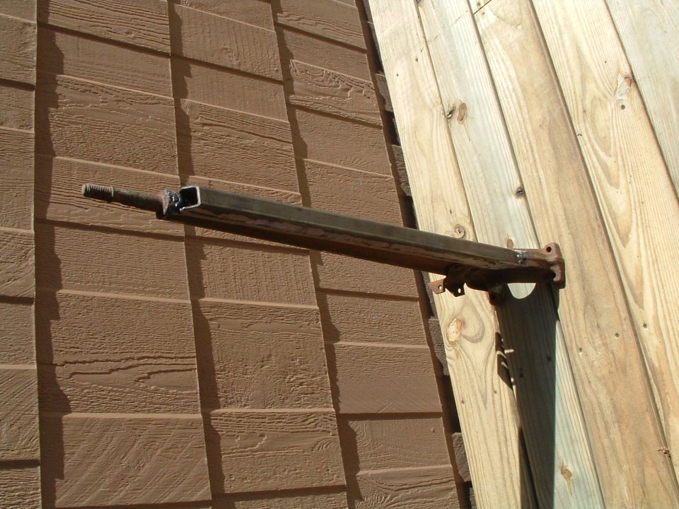 Fabricated steel bar with welded threaded stud on one end and drilled tab bracket on the other