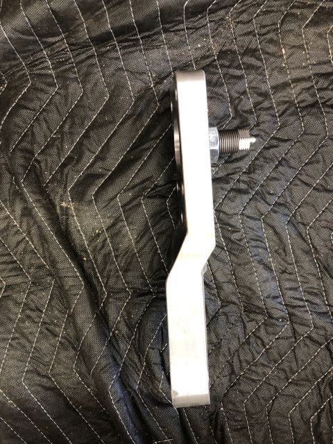 1992 Jeep Wrangler - A single metal automotive part is shown against a quilted black surface.