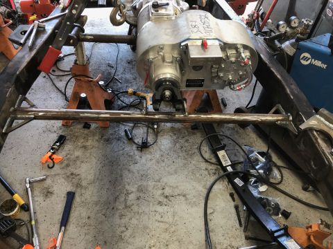 1992 Jeep Wrangler - Close-up view of vehicle frame and drivetrain components being worked on in a garage setting.
