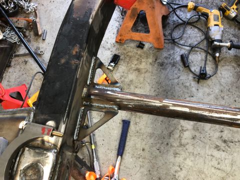 1992 Jeep Wrangler - Close-up view of a vehicle frame section undergoing repair or modification, showing welded joints and attachment points.