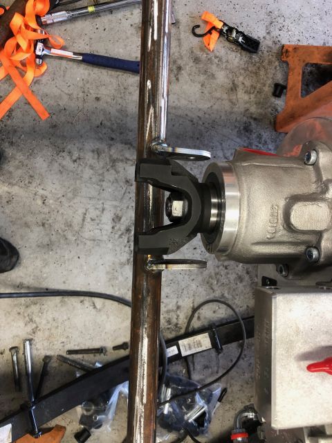 1992 Jeep Wrangler - A driveshaft U-joint connects to a differential housing in a workshop setting.
