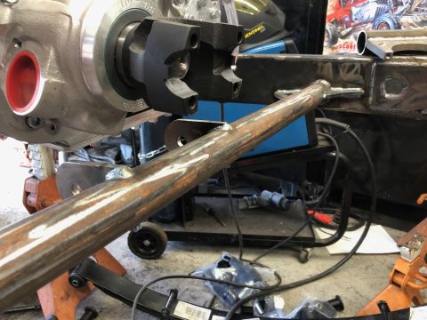 1992 Jeep Wrangler - Close-up of a vehicle's drivetrain and frame components, showing a driveshaft and welded metal tubing.