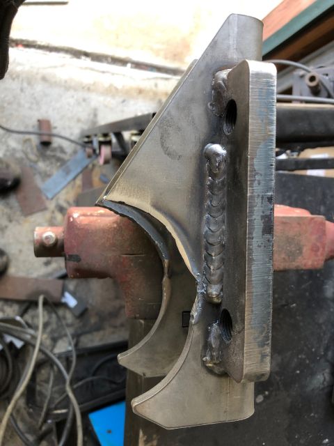 1992 Jeep Wrangler - A custom metal bracket is secured in a vise, ready for further modification or installation.