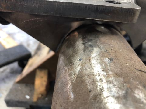 1992 Jeep Wrangler - Detail of a metal suspension part, showing welds and surface imperfections.