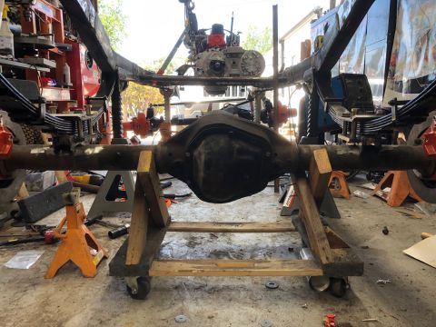 1992 Jeep Wrangler - Suspension components of a Jeep Wrangler are disassembled and supported by jack stands.