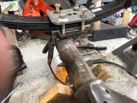 1992 Jeep Wrangler - This photo shows a close-up view of a vehicle's suspension system, specifically a leaf spring and axle assembly.