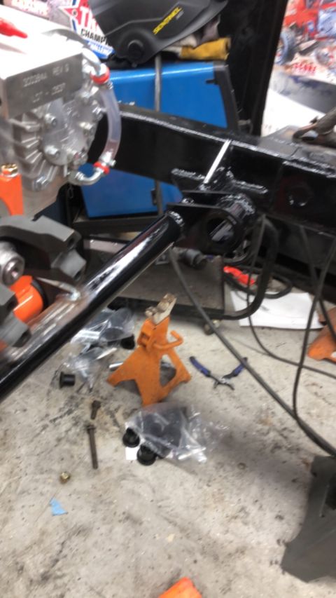 1992 Jeep Wrangler - Vehicle frame and parts laid out on a concrete floor with tools nearby.