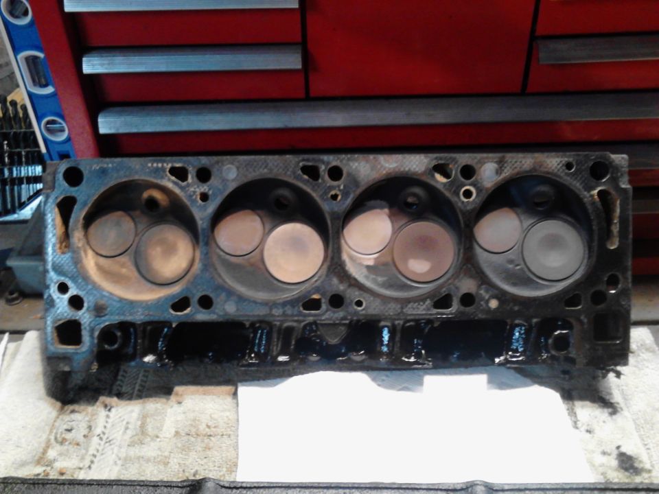 Engine cylinder head with four sets of valves visible