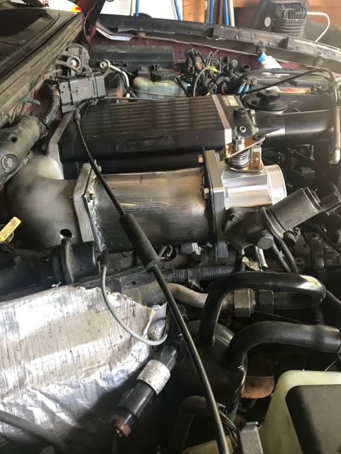 2000 Ford Explorer - Close-up of an engine bay a Kenne Bell supercharger and associated intake plumbing.