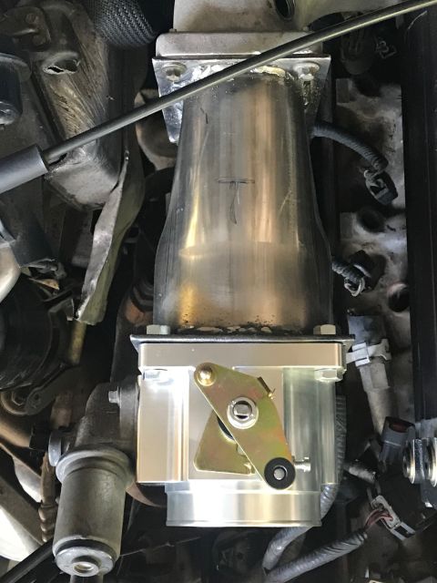 2000 Ford Explorer - This is a close-up view of an engine's throttle body assembly, showing its mechanical components.