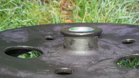Wheel hub part with green and blue cap, Supermotors logo visible