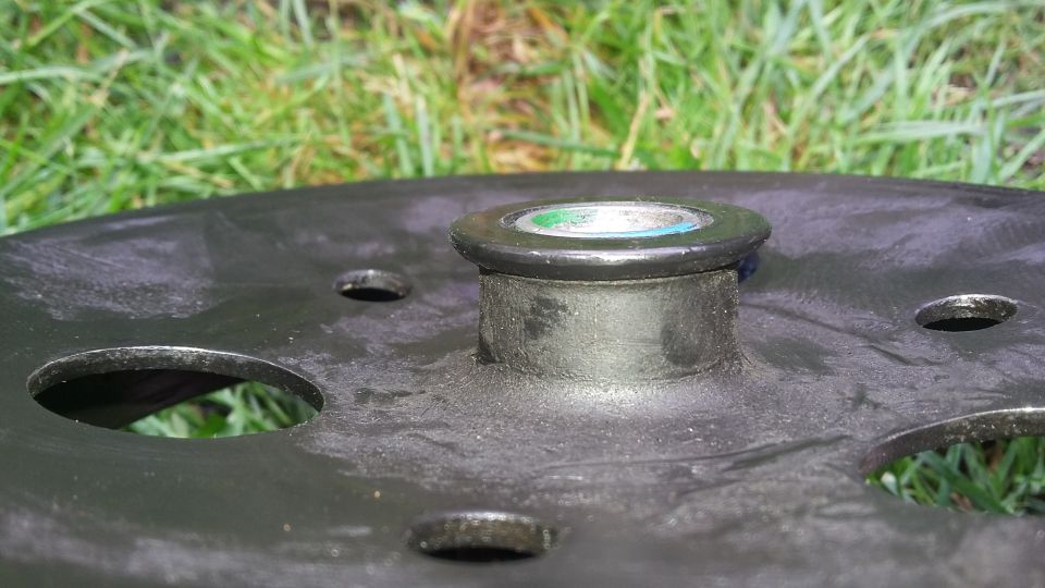 Wheel hub part with green and blue cap, Supermotors logo visible