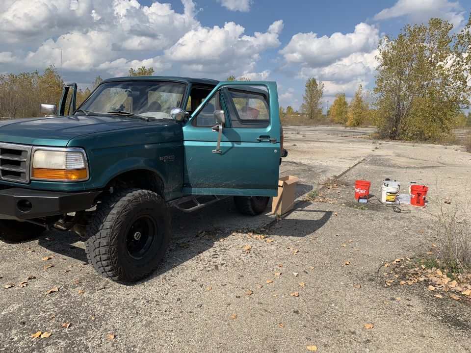 1996 Ford Bronco parked outdoors with driver's door and passenger door open