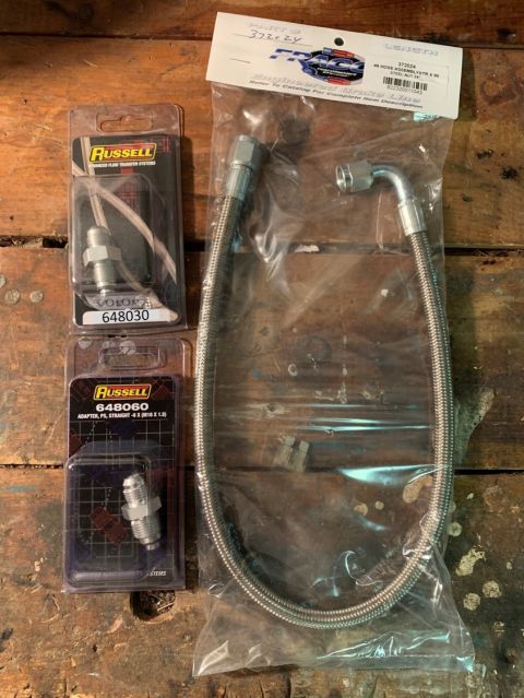 1996 Ford Bronco - Various Russell brand automotive adapters and a braided fuel line hose are displayed.