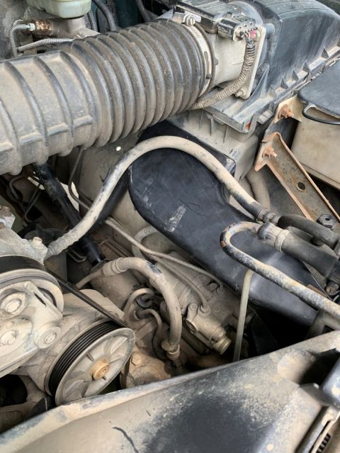 1996 Ford Bronco - Close-up view of the engine bay in a 1996 Ford Bronco, highlighting the air intake system and drive pulleys.