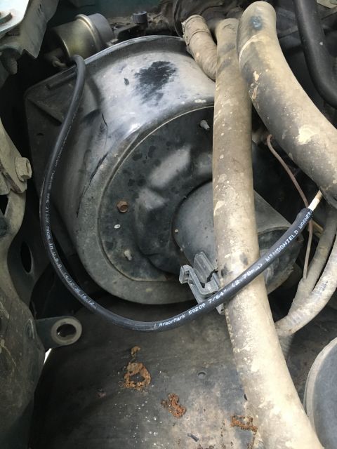 1996 Ford Bronco - Blower motor housing and associated hoses, with visible part numbers and date codes on wiring.