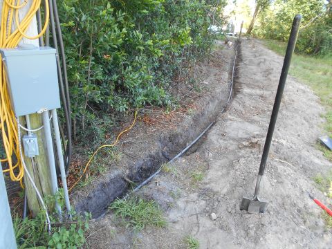 1992 Ford Bronco - Trench dug for electrical conduit installation, with a shovel and electrical box visible.