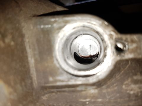 1978 Ford Bronco - A close-up view of a metal cylinder bore, showing signs of wear and oil residue.