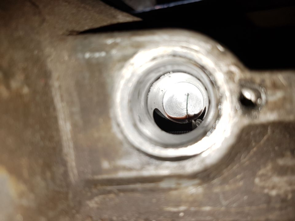 Close-up of a metal cylinder bore with visible oil residue and scoring marks