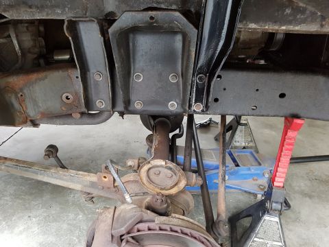 1978 Ford Bronco - Vehicle's underbody and suspension parts are visible, supported by jack stands.