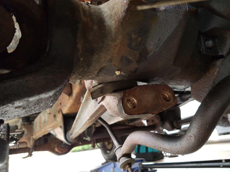 Undercarriage view of rusty suspension and differential with a Supermotors.net watermark