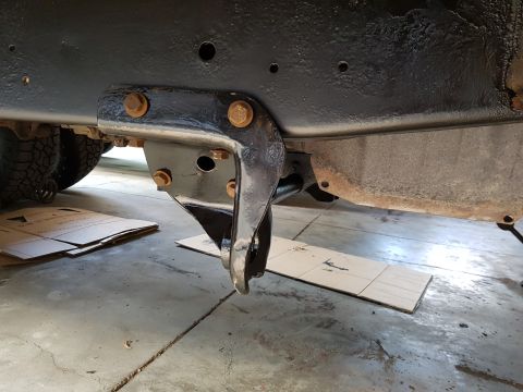 1978 Ford Bronco - Close-up view of a vehicle's undercarriage, focusing on a frame bracket and bolts.