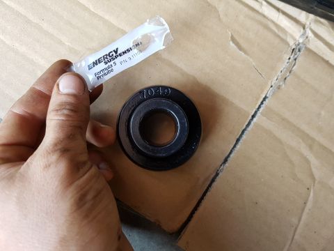 1978 Ford Bronco - A packet of Energy Suspension pre-lube sits next to a part with a stamped number.
