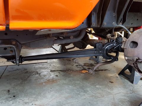 1978 Ford Bronco - Undercarriage view of an orange vehicle, focusing on suspension and frame details.