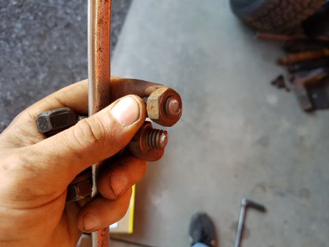 1978 Ford Bronco - A hand holds rusty bolts and a metal rod, with the Supermotors.net logo visible in the background.