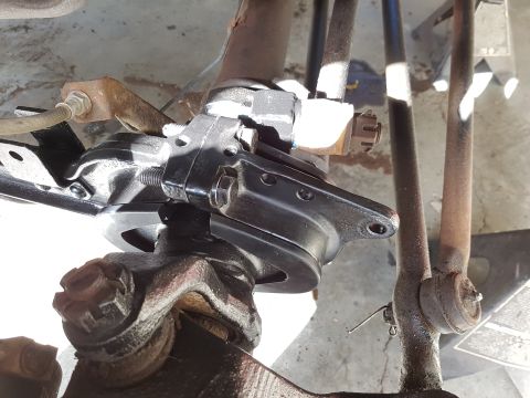 1978 Ford Bronco - Close-up view of a vehicle's steering knuckle and tie rod end assembly.