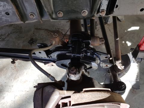 1978 Ford Bronco - Underside view of a vehicle's front suspension and steering system, showing brake components and linkages.