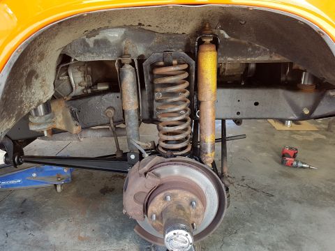 1978 Ford Bronco - Vehicle suspension and brake parts are shown during a repair or modification process.