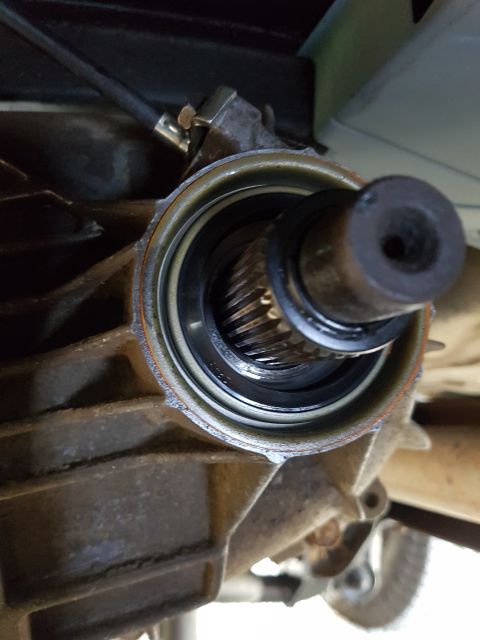 1978 Ford Bronco - Close-up view of a vehicle's driveshaft seal and splined shaft.